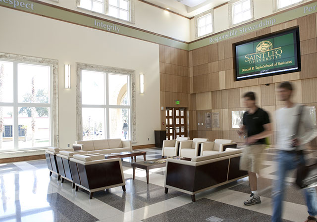 Students walking through lobby of campus building