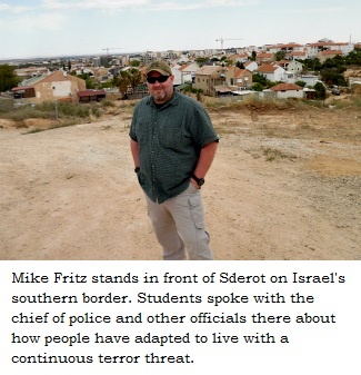 Mike Fritz stands in front of Sderot on Israel's southern border.