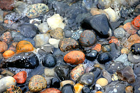 smooth multi-colored rocks in shallow water