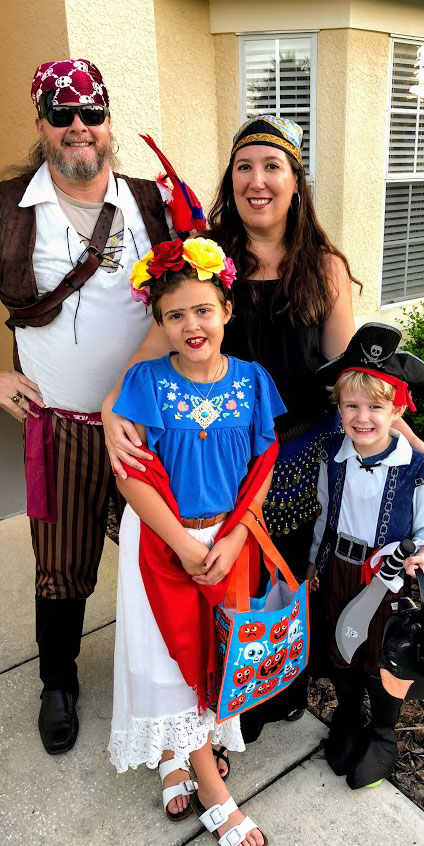 A photo of Saint Leo University professors Drs. Lee Hobbs and Allyson Marino with their two children, Lila and Grayson, all dressed up as pirates for Halloween in 2019
