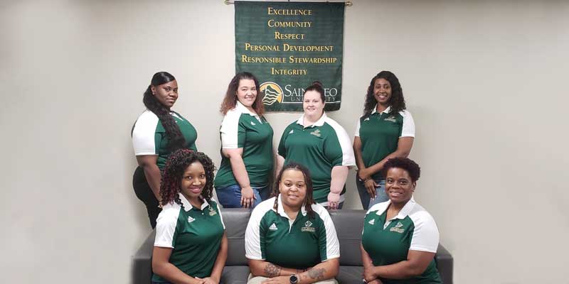A photo of some of the Saint Leo University Savannah Education Center staff: Back row (from left to right) are Joi Williams, Hillary Landuyt, Stephanie Stinski, and Mitria Mobley; front row (left to right) are Yalonka Mitchell, Tanisha Barney, and Khadijah March