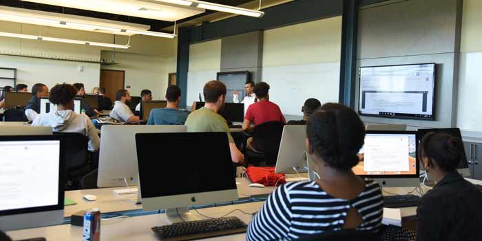 A photo showing a diverse group of software engineering degree students in a classroom at Saint Leo University on its University Campus