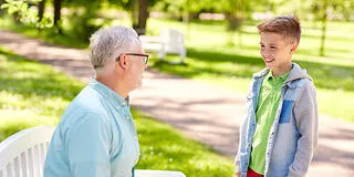 An older man and a child outside