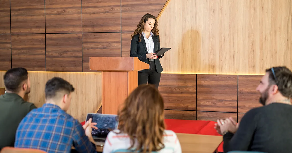 A photo of a female elementary school principal standing with a few students in a room for the blog article on career tracks with an Education Specialist degree from Saint Leo University