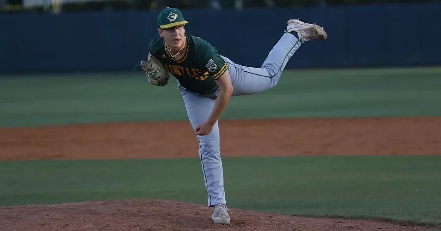 A photo of Andy Booth, a Saint Leo University sport business degree student, pitching for the Saint Leo baseball team; he is wearing his Saint Leo Lions uniform