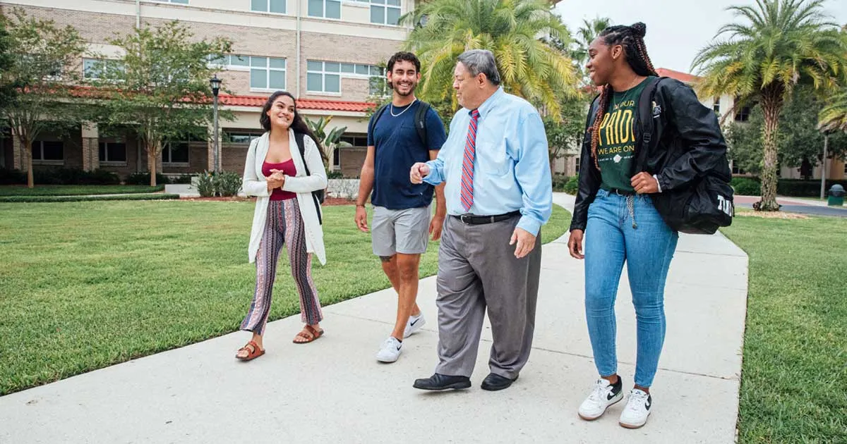 Saint Leo University President, Dr. Dadez walking on campus with students