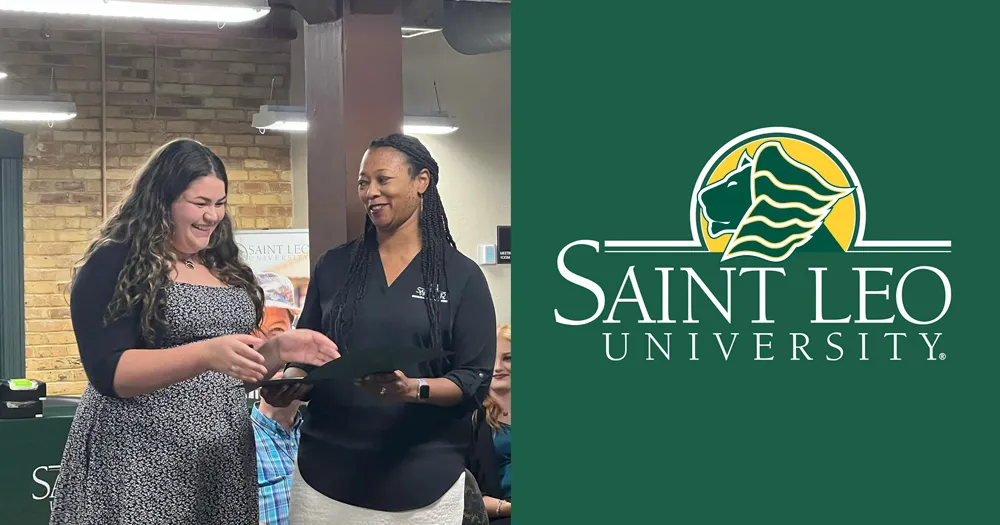 A photo of Megan Rowe, a current undergraduate social work degree student at Saint Leo University, receiving the Leven Chuck Wilson Scholarship from Dr. Ebony Perez at the Influential Women of Social Work event held in the spring of 2022 at the Tampa Education Center