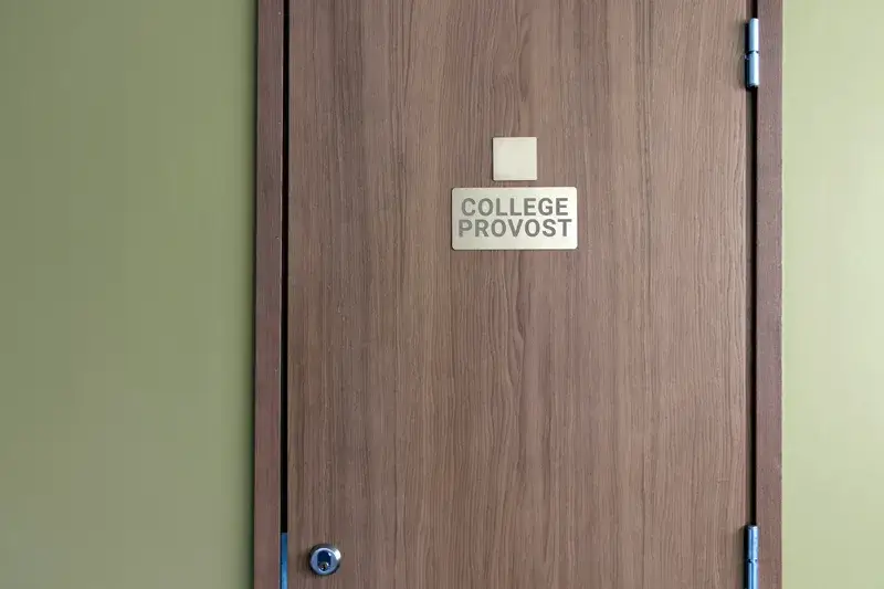 A photo of a sign on a wooden door that reads 'College Provost' for the blog article on career tracks with a master's degree in educational leadership