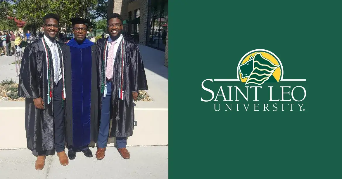 A photo of identical twins Chidozie and Chigozie Igbonagwam, alumni of the Saint Leo biology degree program, standing with their father and Saint Leo computer science professor, Dr. Okey Igbonagwam, at the 2018 Saint Leo University commencement ceremony