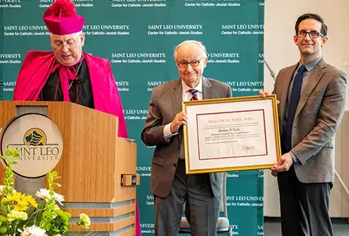 Bishop Mark O’Connell, auxiliary bishop of the Archdiocese of Boston, reads the “parchment” designating Rabbi A. James Rudin as the Papal Knighthood of the Order of St. Gregory.
