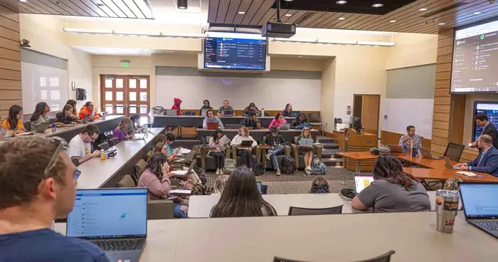 A photo showing several undergraduate students sitting in a classroom, many of whom are using laptops, in one section of the Faith and Politics course offered at Saint Leo University in the spring of 2023; the class was held in TECO Hall in the Tapia College of Business building at University Campus