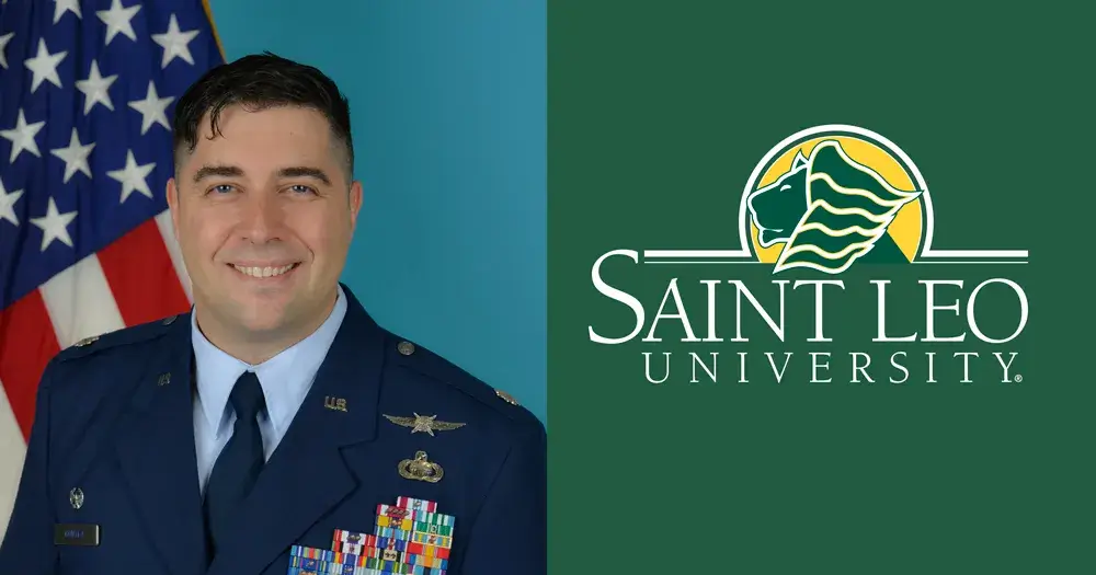 A photo of Jon Gonyea, a current Saint Leo University DBA student, wearing his U.S. Air Force uniform with the American flag in the background