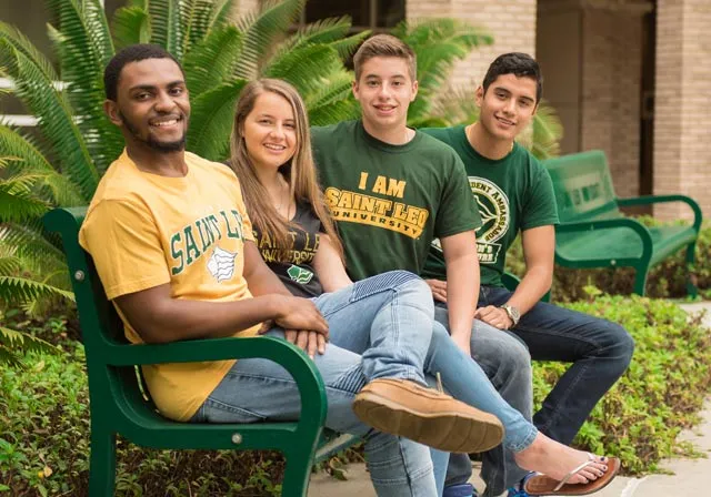Diverse group of Saint Leo students sitting on bench