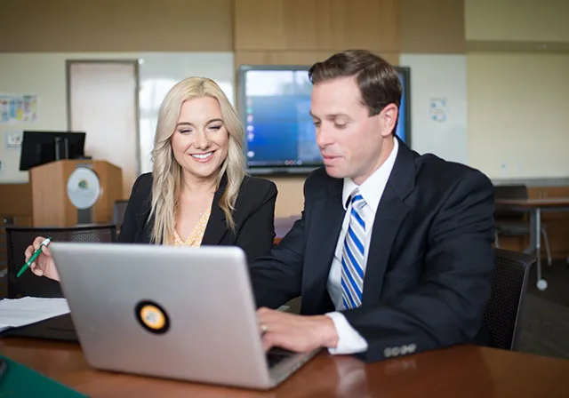 Two co-workers evaluate healthcare business proposal.