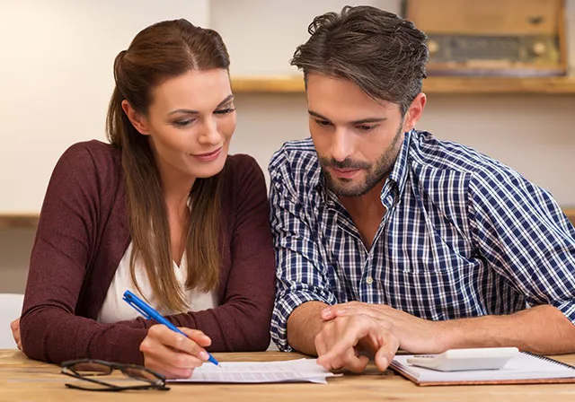 Couple paying the student's tuition bill