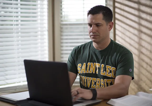Saint Leo student working on a laptop