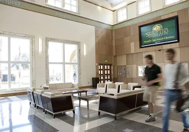 Students walking through lobby of campus building