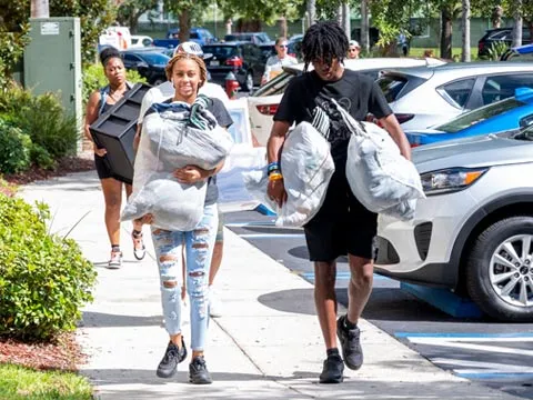 students carrying their things to their dorms