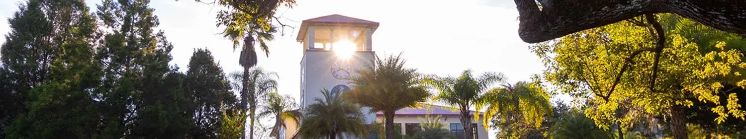 image of sun shining through clocktower on Saint Leo University's campus