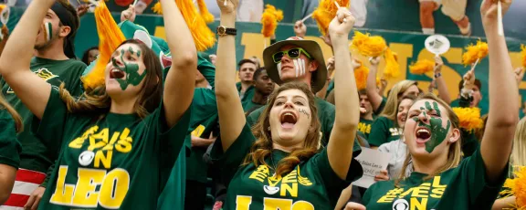 image of students at sporting event cheering for Saint Leo University's Lions