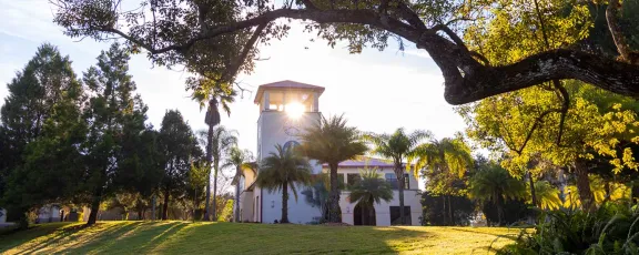 image of sun shining through clocktower on Saint Leo University's campus