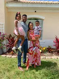 A photo of the Hudson family with parents Rashay and NaDorian and their two children, Rylee and Cameron, standing outside; Rashay Hudson recently completed the master’s in psychology degree program from Saint Leo University