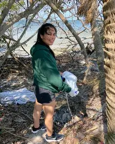 A Saint Leo student cleaning up the beach