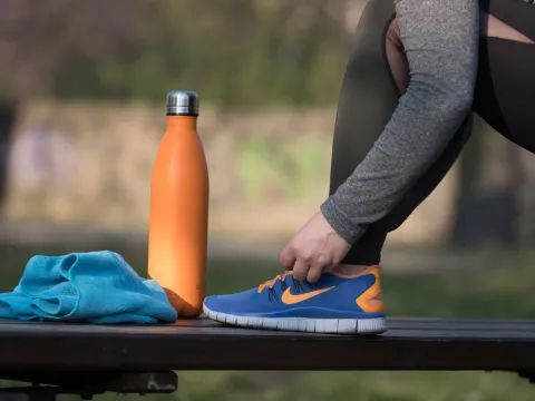 A runner tying their shoes