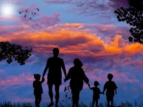 A family outside looking at a sunset