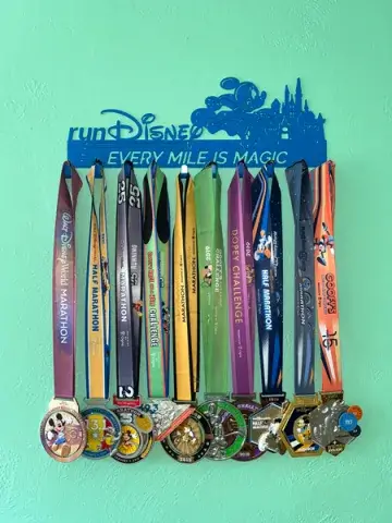 A photo showing several medals won by Dr. Kathryn Duncan from races she has competed in at Disney-sponsored events; Duncan is teaching a sports and literature class this year at Saint Leo University
