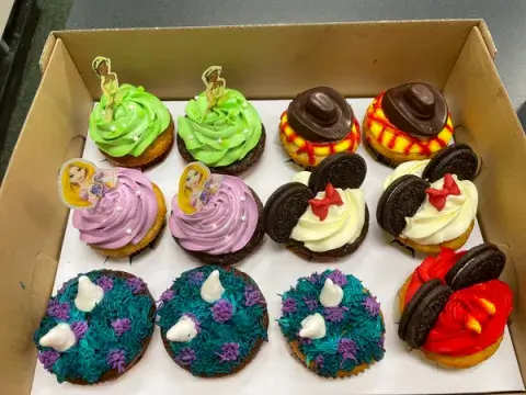 A dozen cupcakes decorated with a Disney theme for the class on Disney psychology at Saint Leo University in the fall of 2022