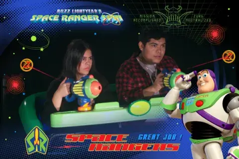 Two students from the class on Disney psychology at Saint Leo University on the Space Rangers ride at Magic Kingdom in October of 2022