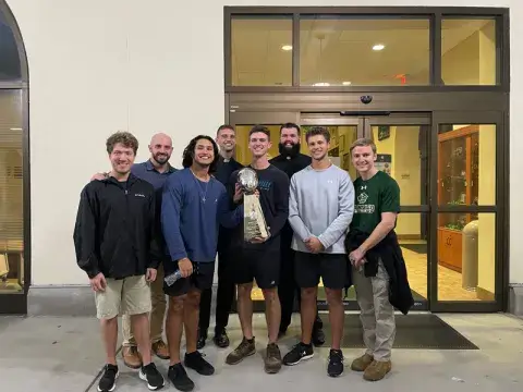 A photo of Rafael Soto, a current political science degree student at Saint Leo University, with members of the University Ministry men’s group after the chaplain of the Tampa Bay Bucs led a ‘Theology on Tap’ event and brought a replica of the Lombardi trophy to University Campus