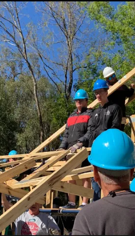 A photo of Phillip Waitkevich, an alumnus of Saint Leo University who was a double major in math and computer science, helping to build a house with some other men through Habitat for Humanity as part of his experience in the EMACS scholars program while he was a student at Saint Leo