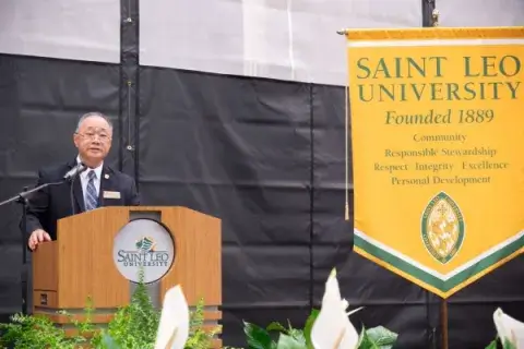 Retired Col. Peter Tan (DDS) speaks at ROTC commissioning
